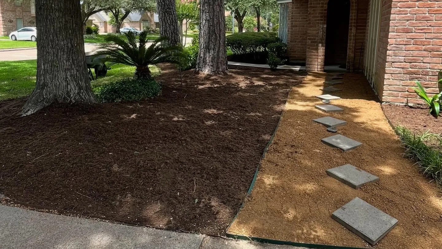 Front yard with stepping stone path and fresh mulch beds by Forest Wood
