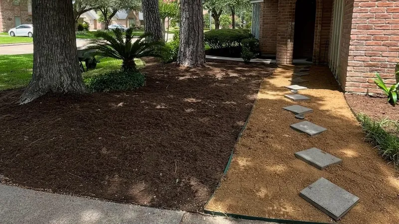 Stepping stone walkway with fresh mulch beds under oak trees